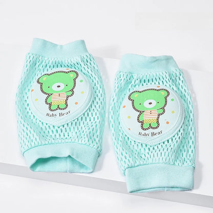 Pair of light green baby knee pads with a green bear design on a white background